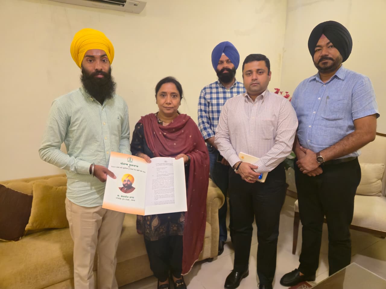 Dr. Baljit Kaur hands over appointment letters to two newly appointed employees of the Social Security Department